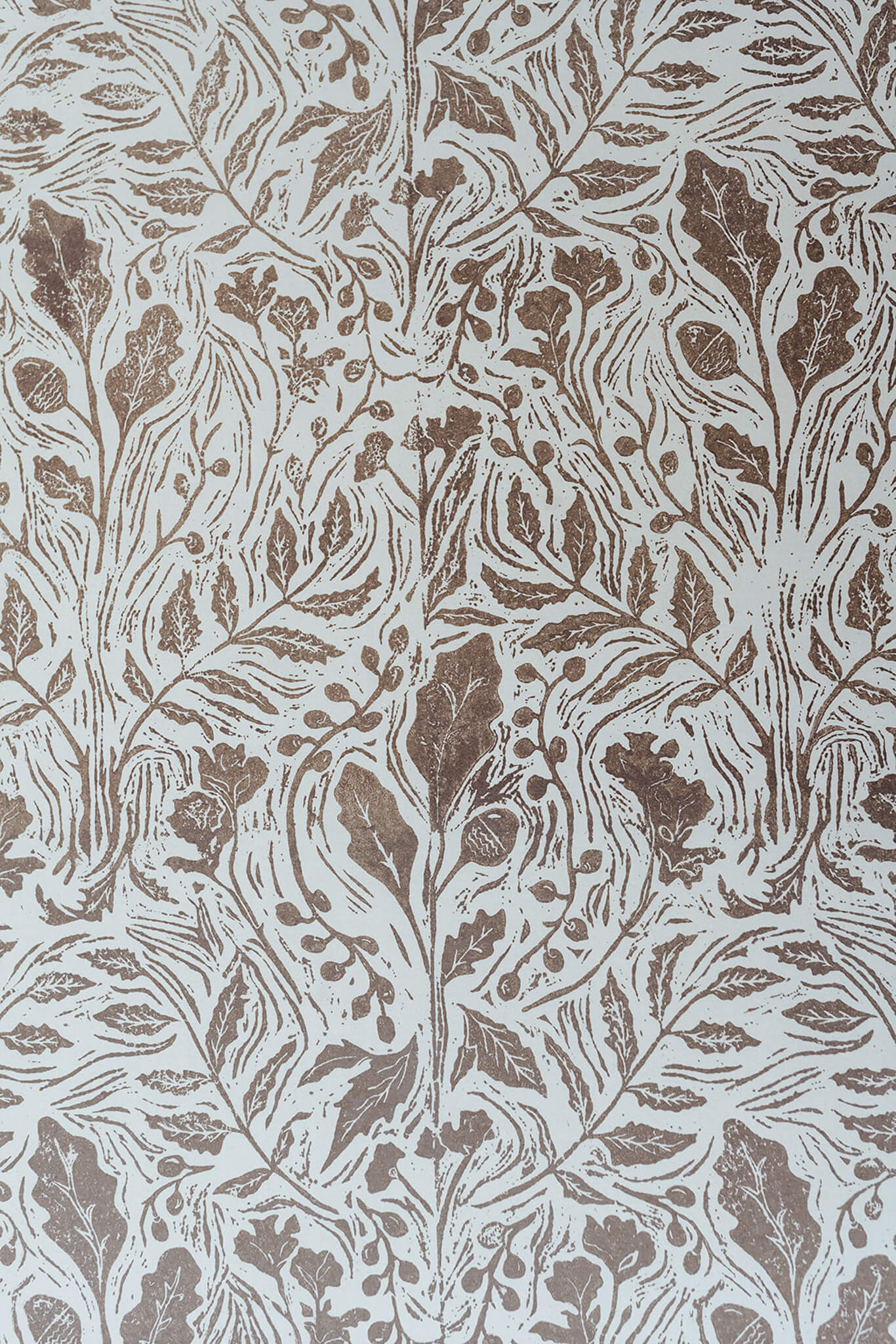Decorative wallpaper with brown leaf pattern on a beige background